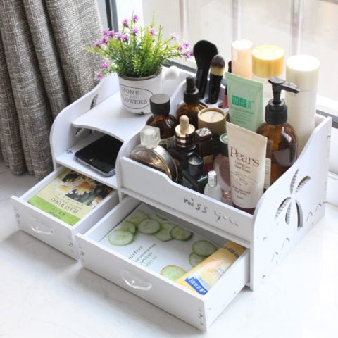 Wooden dressing organizer with cosmetics and accessories on a vanity table, featuring palm tree design.